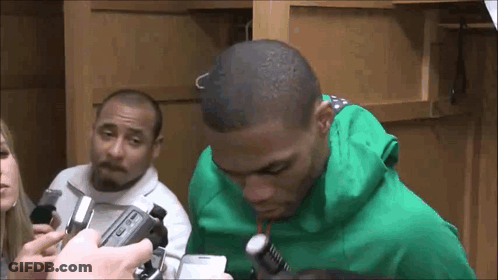 Man In Green Hoodie Being Interviewed By Group GIF