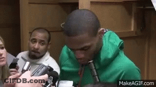 Man In Green Hoodie Interviewed By Group With Microphones GIF