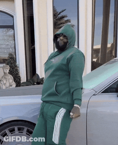 Man In Green Hoodie Leaning Against Car GIF