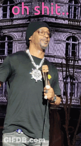 Man In Green Jacket And Tie At Microphone GIF