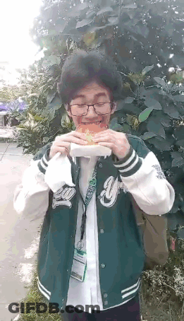 Man In Green Jacket Eating Hamburger GIF