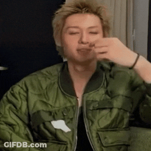 Man In Green Jacket Eating On Couch GIF