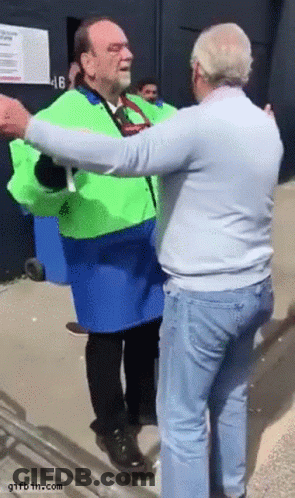 Man In Green Jacket Hugging Man In Blue Jacket GIF