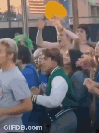 Man In Green Jacket In Crowd GIF