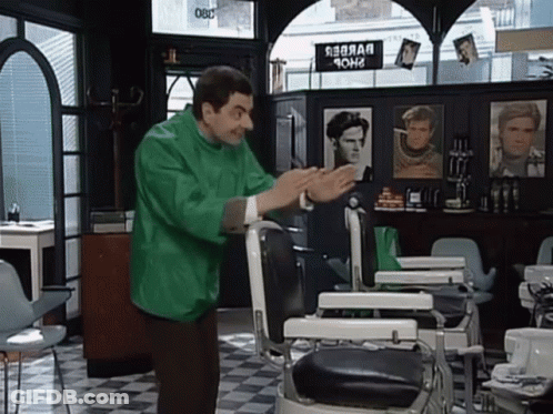 Man In Green Jacket In Front Of Barber Chair GIF