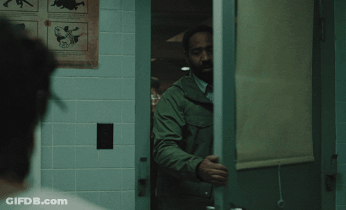 Man In Green Jacket In Front Of Window GIF