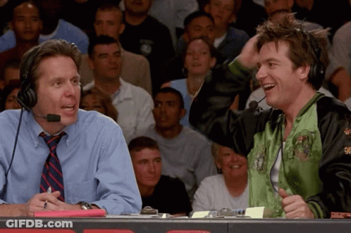 Man In Green Jacket Laughing With Another Man GIF