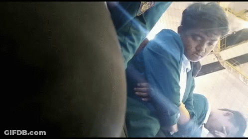 Man In Green Jacket Lying On Floor Eyes Closed GIF