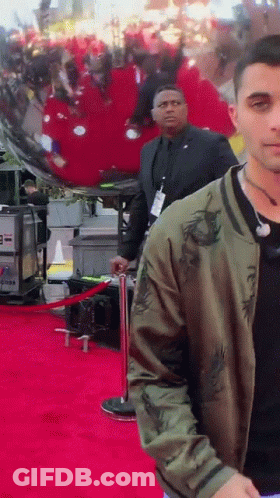 Man In Green Jacket On Red Carpet GIF