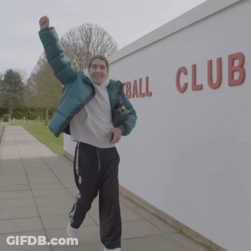 Man In Green Jacket Running In Front Of Ball Club Wall GIF