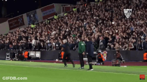 Man In Green Jacket Running On Soccer Field GIF
