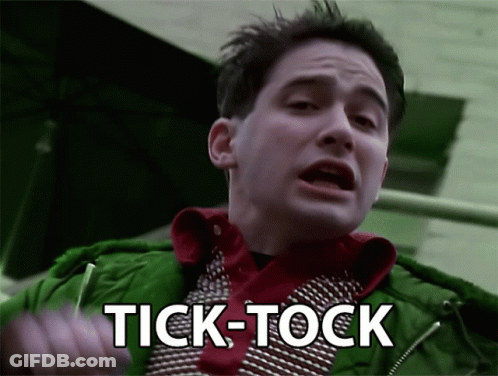 Man In Green Jacket Saying Tick Tock GIF