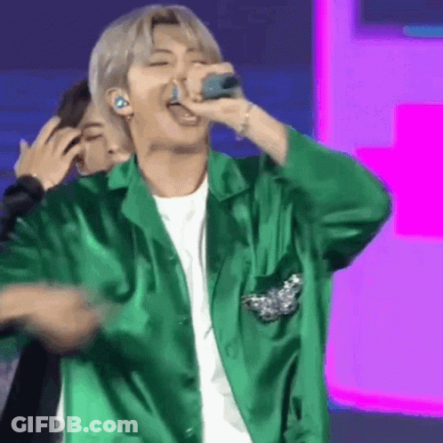 Man In Green Jacket Singing Into Microphone GIF