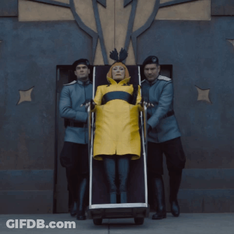 Man In Green Jacket Talking In Dark Room GIF