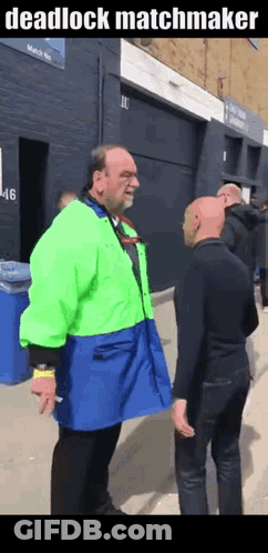 Man In Green Jacket Talking To Another Man GIF
