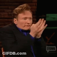 Man In Green Jacket Talking To Another Man GIF