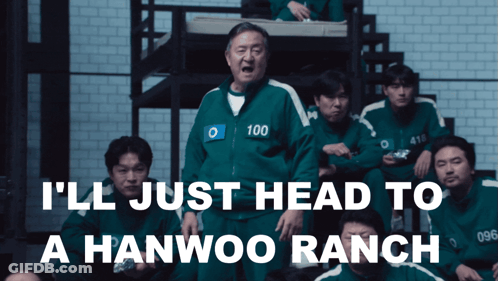 Man In Green Jacket With Number 100 In Front Of Group GIF