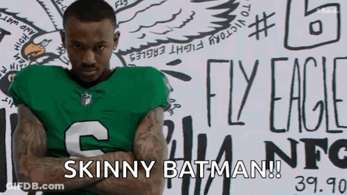 Man In Green Jersey Arms Crossed Says Skinny Batman GIF
