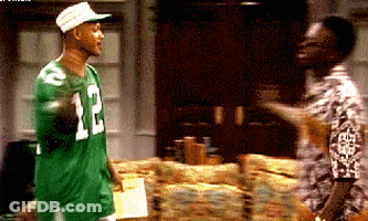 Man In Green Jersey Number 12 Talking To Man GIF