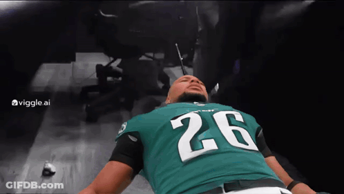 Man In Green Jersey Number 26 Laying On Floor GIF