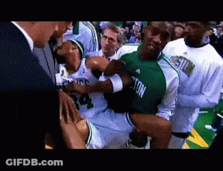 Man In Green Jersey Number 4 Being Carried GIF