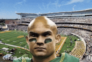 Man In Green Jersey With Sticker On Face In Stadium GIF