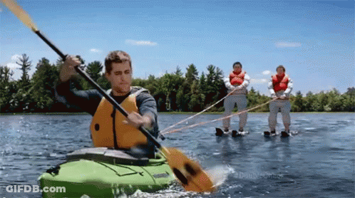 Man In Green Kayak Towed By Two People GIF