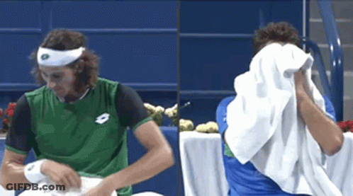 Man In Green Lotto Shirt Wiping Face GIF