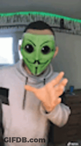 Man In Green Mask Making Peace Sign GIF