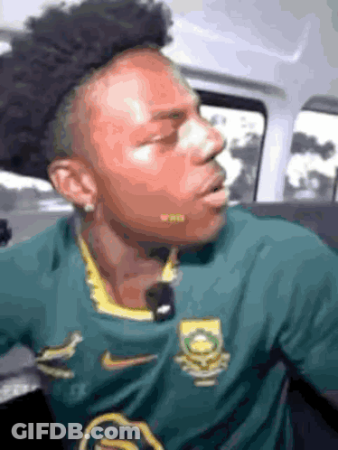 Man In Green Nike Shirt Sitting In Back Seat Of Car GIF