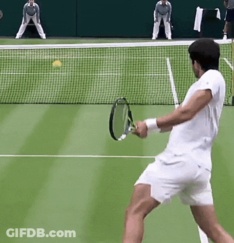 Man In Green Nike Shirt Walking Through Crowd GIF