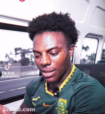 Man In Green Nike Shirt Yellow Collar Looking Down GIF