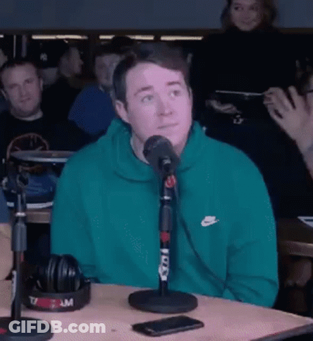 Man In Green Nike Sweatshirt With Microphone GIF