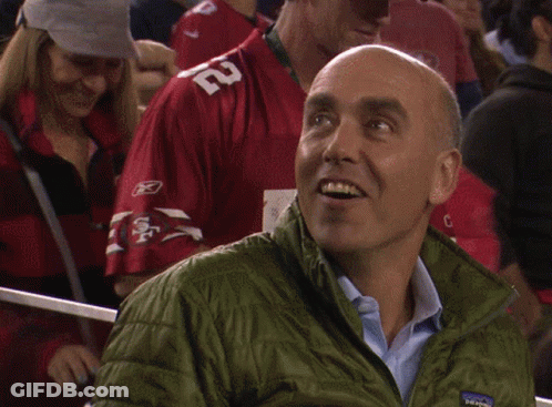 Man In Green Patagonia Jacket Looking Down GIF