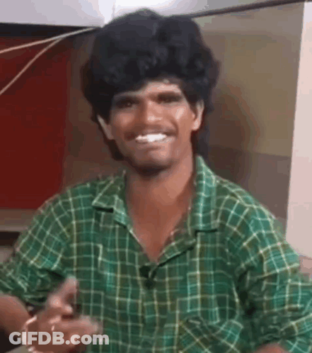 Man In Green Plaid Shirt Smiling And Pointing GIF