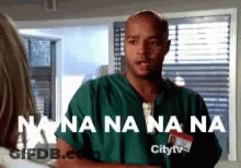 Man In Green Scrub By Window Saying Nana Na Na Na GIF