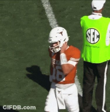 Man In Green Sec Vest Behind Football Player GIF