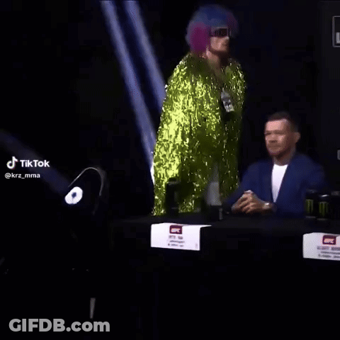 Man In Green Sequined Outfit Dancing At Bud Light Sign GIF