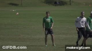 Man In Green Shirt 55 Kicking Frisbee GIF