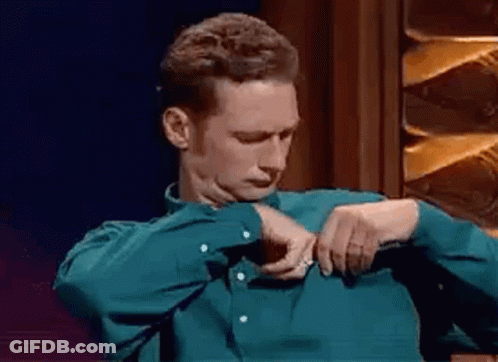 Man In Green Shirt Adjusting Shirt GIF