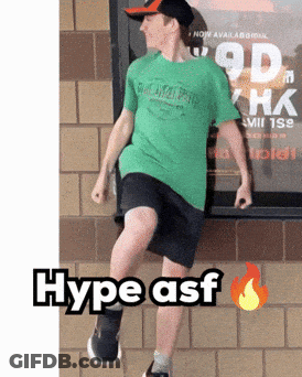 Man In Green Shirt And Black Shorts In Front Of Hype Sign GIF