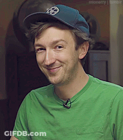 Man In Green Shirt And Blue Hat Smiling GIF