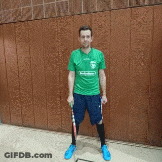 Man In Green Shirt And Blue Shorts Holding Racket GIF
