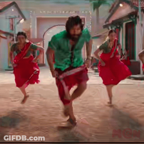 Man In Green Shirt And Red Pants Dancing With Two Women In Red GIF
