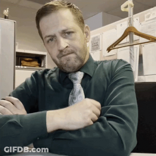 Man In Green Shirt And Tie At Desk GIF