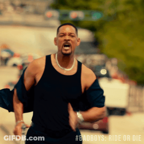 Man In Green Shirt And White Shorts Holding Blue Cape GIF