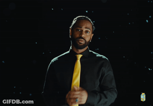 Man In Green Shirt And Yellow Tie With Lemonade Carton GIF