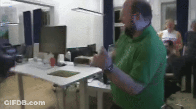 Man In Green Shirt At Computer Desk GIF