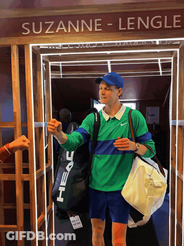 Man In Green Shirt Blue Hat Walking Suzanne Lengle Doorway GIF