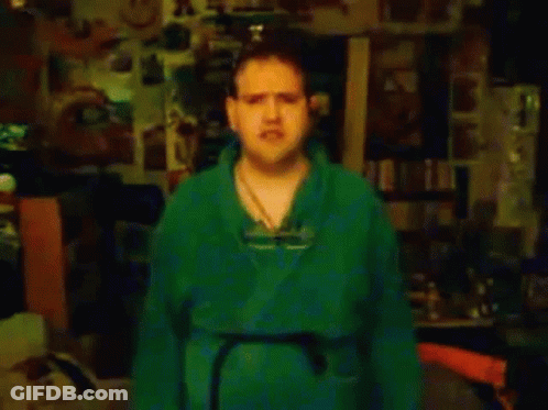 Man In Green Shirt By Ticks Me Off Sign GIF